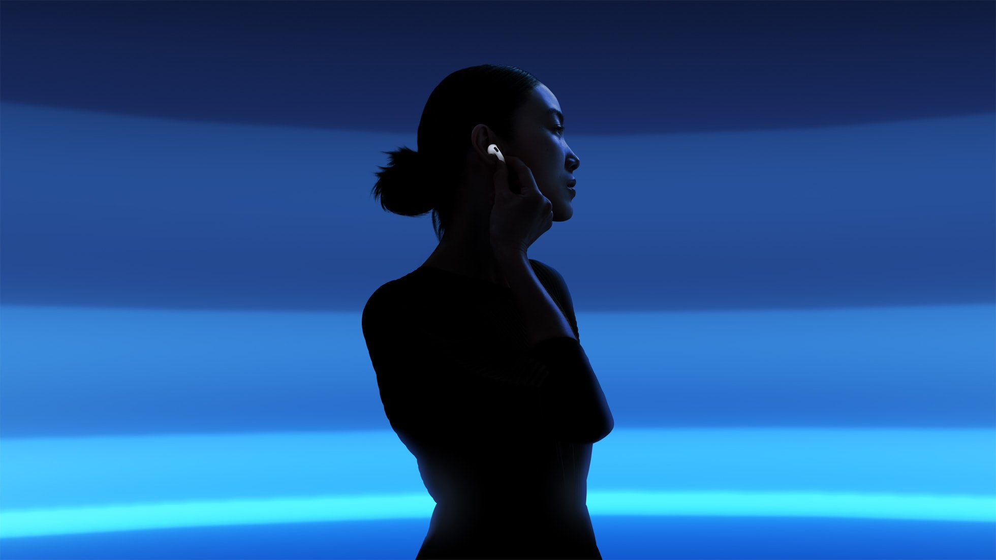 A person wearing a wireless earbud against a blue background